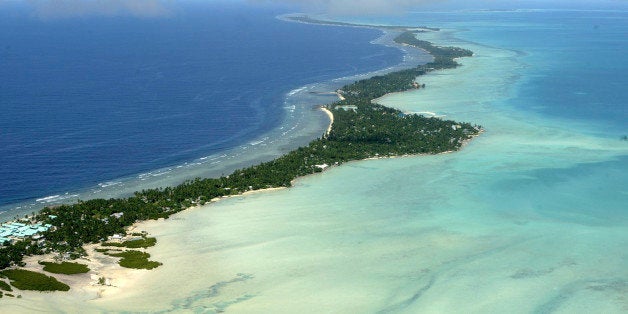 FILE - In this March 30, 2004 file photo, Tarawa atoll, Kiribati, is seen in an aerial view. Fearing that climate change could wipe out their entire Pacific archipelago, the leaders of Kiribati are considering an unusual backup plan: moving the populace to Fiji. Kiribati President Anote Tong told The Associated Press on Friday, March 9, 2012 that his Cabinet this week endorsed a plan to buy nearly 6,000 acres on Fiji's main island, Viti Levu. He said the fertile land, being sold by a church group for about $9.6 million, could provide an insurance policy for Kiribati's entire population of 103,000, though he hopes it will never be necessary for everyone to leave. (AP Photo/Richard Vogel, File)