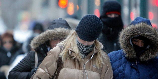 FILE- In this Jan. 28, 2014, file photo, morning commuters bundle up in Chicago. Meteorologists are confidently forecasting f