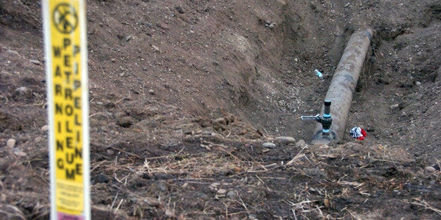 A warning sign shows the location of a 12-inch oil pipeline owned by Bridger Pipeline Co. that spilled up to 50,000 gallons o