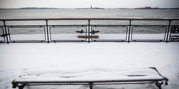 NEW YORK, NY - JANUARY 27: A park bench is covered in snow after a snowstorm on January 27, 2015 in New York City. The storm, which was predicted to dump 20-30 inches of snow causing roads, highways and the subway to be shut down, was weaker than expected in New York City but hit Eastern Long Island and the New England region with full force. (Photo by Andrew Burton/Getty Images)