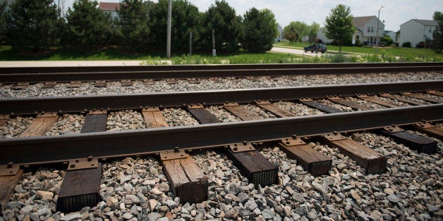 Train tracks utilized by freight trains for the transport of freight, including crude oil, stand across the street from a residential housing development in Plainfield, Illinois, U.S., on Friday, June 27, 2014. Last year's derailment in Quebec that killed 47 people and seven other major ones in the U.S. and Canada have spilled more than 3 million gallons of oil, with some cars catching fire or exploding. Photographer: Daniel Acker/Bloomberg via Getty Images