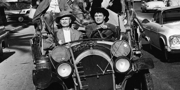 Clockwise from left: American actresses Donna Douglas and Irene Ryan (1902 - 1973) and American actors Max Baer Jr. and Buddy Ebsen (1908 - 2003) drive in a convertible car in an episode of the television series 'The Beverly Hillbillies,' Los Angeles, California, 1960s. A dog sits between Douglas and Ryan. (Photo by CBS/Courtesy of Getty Images)