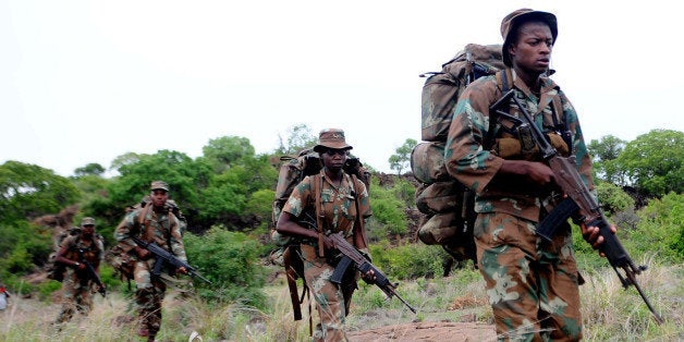 South African anti-poaching task team patrol in Kruger National Park on November 26, 2013. South African conservation authorities on November 26 said they aim to reduce rhino poaching by 20 percent a year, insisting their strategy is working despite record levels of poaching. 'The war against poaching is not yet won, but we can reduce the figures... it's an ongoing process,' said Major General Johan Jooste, who heads the Kruger National Park anti-poaching task team. The number of rhino killed this year for their horns has hit a record 860 so far, despite the deployment of the army and the use of helicopters and drone patrols. AFP PHOTO / STRINGER (Photo credit should read STRINGER/AFP/Getty Images)