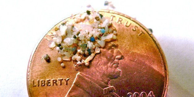 FILE - In this 2012 file photo provided by 5gyres.org, a sample of "microbeads" collected in eastern Lake Erie is shown on the face of a penny. Illinois environmentalists expecting a battle with business over a call for a ban on the tiny bits of plastic used in personal care products, found the industry quickly collaborated. With similar bans pending in at least three other large states, the extinction of microbeads, now showing up inside fish that are caught for human consumption, is happening in an unusually short amount of time. (AP Photo/Courtesy 5gyres.org, Carolyn Box, File)