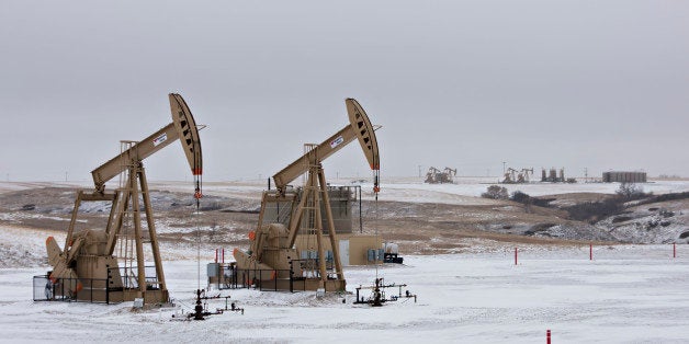 Pumpjacks operate at an oil well in Williston, North Dakota, U.S., on Sunday, Feb. 15, 2015. A plunge in global energy prices that has put some North Dakota oil rigs in a deep freeze has yet to chill the state's hiring climate. Photographer: Daniel Acker/Bloomberg via Getty Images