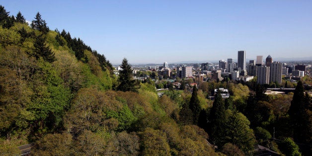 In this Wednesday, April 24, 2013 photo, the forested hills west of downtown Portland, Ore., shown here are honeycombed with miles and miles of hiking trails. One of the latest Portland efforts is something called the 4T trail, a tour that incorporates the city's light-rail trains, trolleys, forest trails and even a sky tram that gives spectacular views of downtown and the surrounding countryside from the West Hills. (AP Photo/Don Ryan)