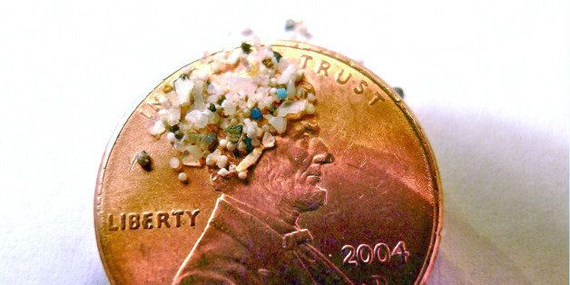 FILE - In this 2012 file photo provided by 5gyres.org, a sample of "microbeads" collected in eastern Lake Erie is shown on the face of a penny. Illinois environmentalists expecting a battle with business over a call for a ban on the tiny bits of plastic used in personal care products, found the industry quickly collaborated. With similar bans pending in at least three other large states, the extinction of microbeads, now showing up inside fish that are caught for human consumption, is happening in an unusually short amount of time. (AP Photo/Courtesy 5gyres.org, Carolyn Box, File)