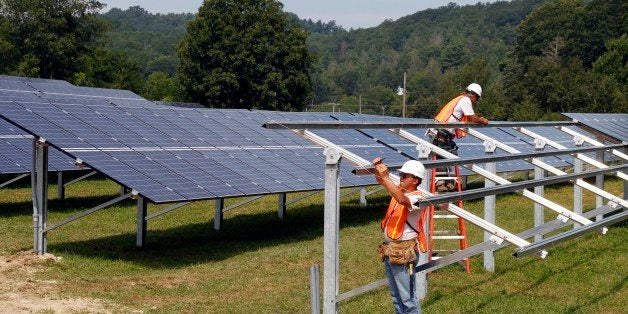 Crews complete construction of the solar panel structure at the O2 Energies solar panel farm in Newland, N.C., Thursday, Aug. 4, 2011. Of the 11 states that do not set voluntary or mandatory requirements on how much green energy utilities must buy, eight of those states are clustered in the Southeast. Supporters say forcing utilities to buy set amounts of renewable energy helps develop power sources that do not depend on fossil fuels, emit fewer of the gasses blamed for global warming and help create jobs and the development of new technology. Conservative politicians in the Southeast typically oppose government mandates and worry the efforts could raise energy prices in a recession and hurt manufacturing jobs. (AP Photo/Bob Leverone)