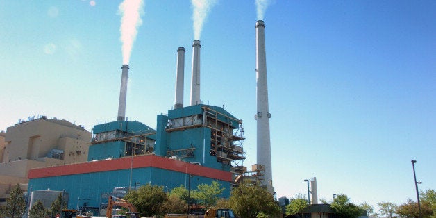 FILE - In this July 1, 2013, file photo, smoke rises from the Colstrip Steam Electric Station, a coal burning power plant in in Colstrip, Mont. State officials planned a public meeting Tuesday, Sept. 30, 2014, in Colstrip on the U.S. Environmental Protection Agency proposal to cut greenhouse emissions. The town is home to one of the largest coal-fired power plants in the West, a 2,100-megawatt facility that churns out more greenhouse gases than any other source in Montana. (AP Photo/Matthew Brown, File)