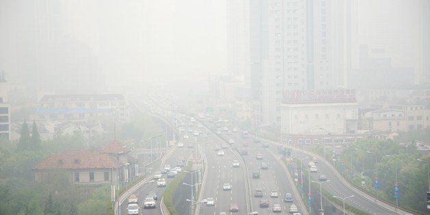 Cars are seen on an elevated road on a heavy polluted day in Shanghai on April 19, 2015. AFP PHOTO / JOHANNES EISELE (Photo credit should read JOHANNES EISELE/AFP/Getty Images)