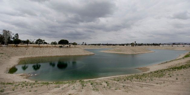 A water holding pond at the Orange County Water District, recharge facility is filled to less then 20 percent of it's capacity, Wednesday, May 6, 2015 in Anaheim, Calif. The State Water Resources Control Board approved new restrictions Tuesday that include a mandatory target for each local water agency to reduce consumption. (AP Photo/Chris Carlson)
