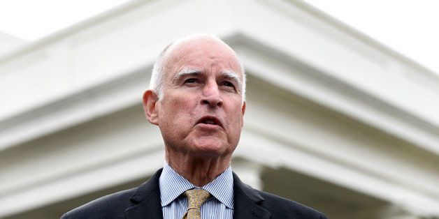 California Gov. Jerry Brown speaks to reporters outside the White House in Washington, Friday, March 13, 2015. Brown is defending President Barack Obamaâs efforts to spare from deportation millions of people who are in the U.S. illegally, as well as his own stateâs economic progress during a White House visit on Friday. (AP Photo/Susan Walsh)