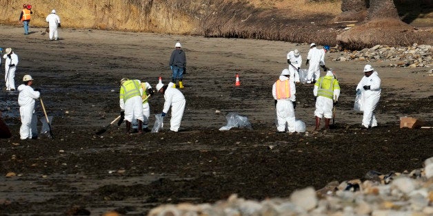 Clean up crews remove oil-laden sand on the beach at Refugio State Beach, site of an oil spill, north of Goleta, Calif., Wednesday, May 20, 2015. A broken onshore pipeline spewed oil down a storm drain and into the ocean for several hours Tuesday before it was shut off, creating a slick some 4 miles long about 20 miles west of Santa Barbara. (AP Photo/Michael A. Mariant)