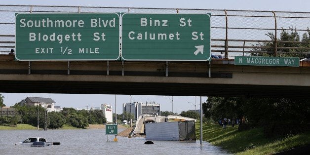 Vehicles are left stranded on Texas State Highway 288 in Houston, Texas on May 26, 2015. Heavy rains throught Texas put the city of Houston under massive amounts of water, closing roadways and trapping residents in their cars and buildings, according to local reports. Rainfall reached up to 11 inches (27.9cm) in some parts of the state, according to national forecasters, and the heavy rains quickly pooled over the state's already saturated soil. AFP PHOTO/AARON M. SPRECHER (Photo credit should read Aaron M. Sprecher/AFP/Getty Images)