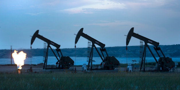 NEW TOWN, ND - AUGUST 13: View of three oil wells and flaring of natural gas on The Fort Berthold Indian Reservation near New Town, ND on August 13, 2014. About 100 million dollars worth of natural gas burns off per month because a pipeline system isn't in place yet to capture and safely transport it . The Three Affiliated Tribes on Fort Berthold represent Mandan, Hidatsa and Arikara Nations. It's also at the epicenter of the fracking and oil boom that has brought oil royalties to a large number of native americans living there. More income has also translated to more crime on the resvation in the form of meth use and additction, drunk driving, assaults and domestic violence. A small tribal police force is finding it difficult to cover the nearly one-million acre reservation as well as retain officers. (Photo by Linda Davidson / The Washington Post via Getty Images)