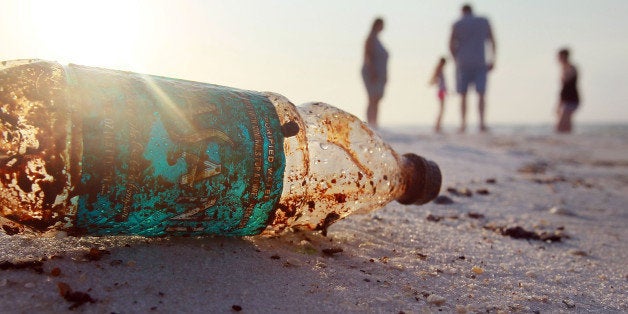 PENSACOLA, FL - JUNE 06: A plastic bottle is seen coated in oil on Pensacola Beach as oil makes its way on shore from the Deepwater Horizon oil spill in the Gulf of Mexico on June 6, 2010 in Pensacola, Florida. Early reports indicate that BP's latest plan to stem the flow of oil from the site of the Deepwater Horizon incident may be having some sucess. (Photo by Joe Raedle/Getty Images)