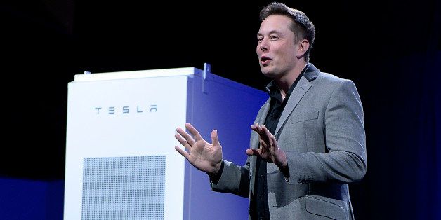 LOS ANGELES, CA - APRIL 30: Elon Musk, CEO of Tesla, with a Powerpack unit the background unveils suit of batteries for homes, businesses, and utilities at Tesla Design Studio April 30, 2015 in Hawthorne, California. Musk unveiled the home battery named Powerwall with a selling price of $3500 for 10kWh and $3000 for 7kWh and very large utility pack called Powerpack. (Photo by Kevork Djansezian/Getty Images)