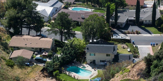 Homes with swimming pool are seen, Thursday April 2, 2015 in Altadena, Calif. California Gov Jerry Brown on Wednesday, April