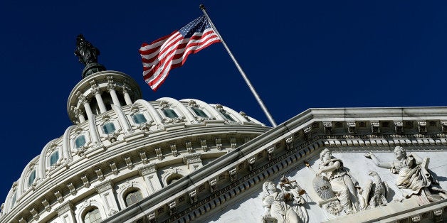 WASHINGTON, DC - SEPTEMBER 29: An American flag waves outside the United States Capitol building as Congress remains gridloc
