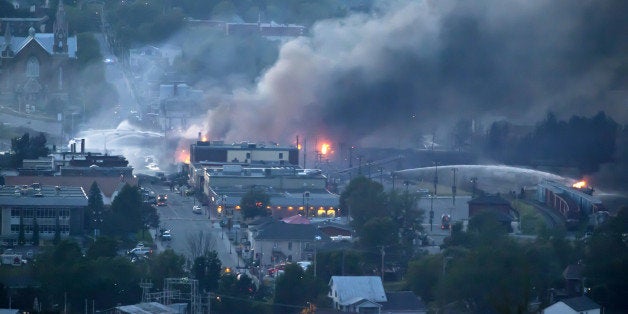 (FILES) File photo dated July 6, 2013 shows firefighters dousing blazes after a freight train loaded with oil derailed in Lac-Megantic in Canada's Quebec province, sparking explosions that engulfed about 30 buildings in fire. Police have been raiding the head offices of the Montreal, Maine and Atlantic Railway company (MMA) in Farnham, Canada, a few hours drive from Lac-MÃ©gantic July 25, 2013. The accident left 47 dead when the oil tanker train derailed and exploded earlier that month. AFP PHOTO / FranÃ§ois Laplante-Delagrave (Photo credit should read FranÃ§ois Laplante-Delagrave/AFP/Getty Images)