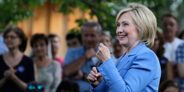 Democratic presidential candidate Hillary Rodham Clinton smiles as she listens to a question during a house party in Windham, N.H., Thursday, July 16, 2015. (AP Photo/Charles Krupa)