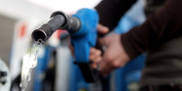 MUNICH, GERMANY - MARCH 23: In this photo illustration a man refuels his car on March 23, 2010 in Munich, Germany. German President Horst Koehler said higher petrol prices could help make Germans become more environmentally conscious. (Photo Illustration by Miguel Villagran/Getty Images)