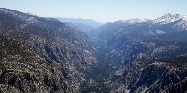 A valley in the Sequoia National Park normally covered in snow this time of year is seen during an aerial survey of the snowpack done by the Californian Department of Water Resources, Tuesday, April 28, 2015. California is in its fourth year of drought, and state officials fear it may last as long as a decade. State water officials on Tuesday toured the High Sierra by helicopter, finding snow at only one of four sites that normally would be covered, said Frank Gehrke, chief of snow surveys for the California Department of Water Resources. (AP Photo/Rich Pedroncelli)