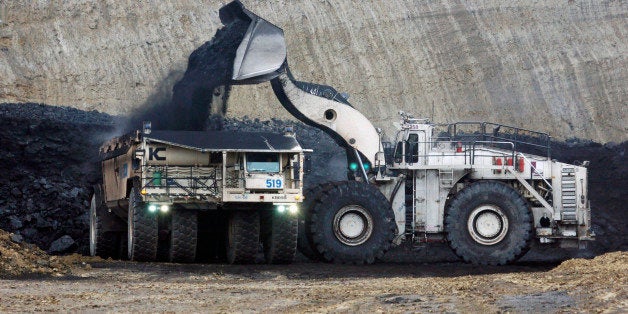 FILE - In this March 28, 2007 file photo, lignite coal is mined at the Freedom Mine in Beulah, N.D. Under a series of rulings by U.S. judges in Denver over the last year, federal agencies that approve mining projects have been told to take into account coal's indirect environmental impact along with traditional concerns about mine dust and equipment emissions. (AP Photo/James MacPherson, File)