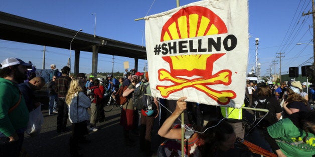 Protesters rally at the Port of Seattle, Monday, May 18, 2015, in Seattle. Demonstrators opposed to Arctic oil drilling were showing opposition to a lease agreement between Royal Dutch Shell and the Port to allow some of Shell's oil drilling equipment to be based in Seattle. (AP Photo/Ted S. Warren)