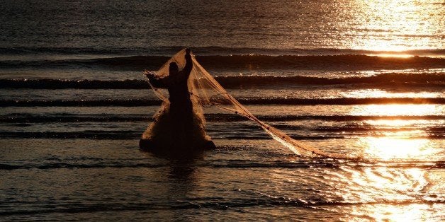 An Albanian fisherman throws his net at the shore in Vlora, 140 kilometers (85 miles) southwest of capital Tirana, Tuesday, Dec. 30, 2014. Fishing is often the main source of income for many poor families in the West Balkan tiny country, still among the poorest countries in the continent. (AP Photo/Hektor Pustina)