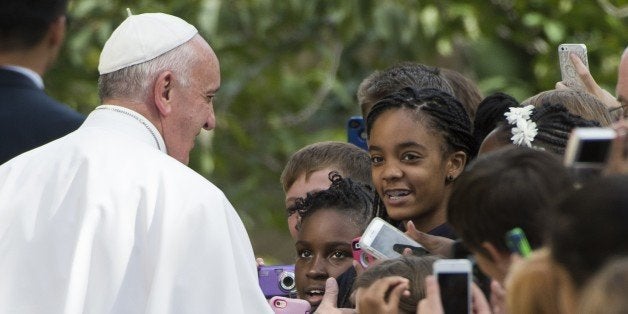 Pope Francis greets well-wishers as he leaves the Apostolic Nunciature to the United States on September 24, 2015 in Washing