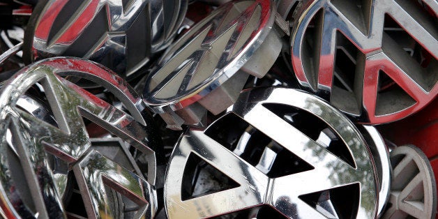 Volkswagen ornaments sit in a box in a scrap yard in Berlin, Germany, Wednesday, Sept. 23, 2015. The revelation that Volkswag