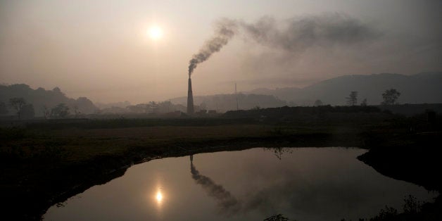 Smoke rises from a brick kiln on the outskirts of Gauhati, India, Monday, Jan. 26, 2015. The White House is hoping that the s