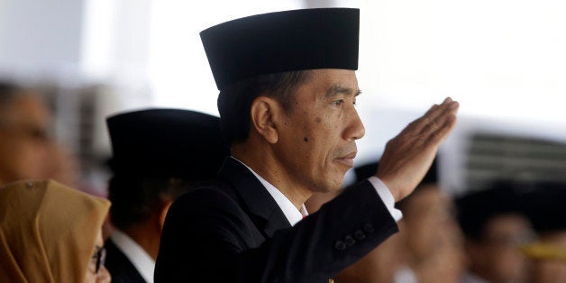 Indonesia's President Joko Widodo salutes during a flag raising ceremony for Independence Day at Merdeka Palace in Jakarta, Indonesia, Monday, Aug. 17, 2015. Indonesia is marking the 70th anniversary of its declaration of independence from Dutch colonial rule. (AP Photo/Achmad Ibrahim)