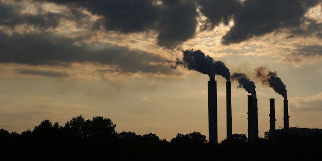 The silhouettes of emissions are seen rising from stacks of the Duke Energy Corp. Gibson Station power plant at dusk in Owensville, Indiana, U.S., on Thursday, July 23, 2015. Coal reclaimed its ranking as the top fuel for generating electricity at U.S. power plants in May, beating natural gas, which took the number one spot for the first time in April. Photographer: Luke Sharrett/Bloomberg via Getty Images