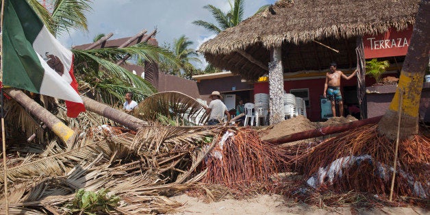 MELAQUE, MEXICO - OCTOBER 24: Workers clean out the 'Terrza Cortes' restaurant after damage from Hurricane Patricia October 2