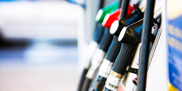 Row of fuel pumps at a gas station, shot with shallow depth of field. Car in the background. Camera: Canon EOS 1Ds Mark III.