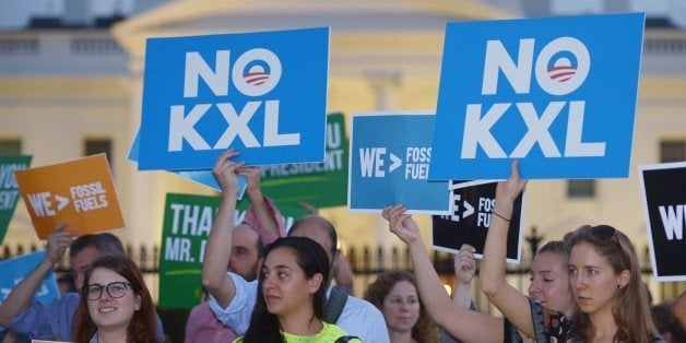 Activists, celebrating US President Barack Obama's blocking of the Keystone XL oil pipeline, rally in front of the White House in Washington, DC on November 6, 2015. US President Barack Obama blocked the Keystone XL oil pipeline that Canada sought to build into the United States, ruling it would harm the fight against climate change. AFP PHOTO/MANDEL NGAN (Photo credit should read MANDEL NGAN/AFP/Getty Images)