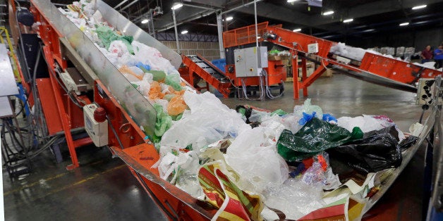 FILE-This Friday, Jan. 24, 2014 file photo conveyors carry mixed plastic into a device that will shred recycle them at a plastics recycling plant in Vernon, Calif. Gov. Jerry Brown has signed legislation on Tuesday, Sept. 30, 2014 imposing the nation's first statewide ban on single-use plastic bags. (AP Photo/Reed Saxon,File)