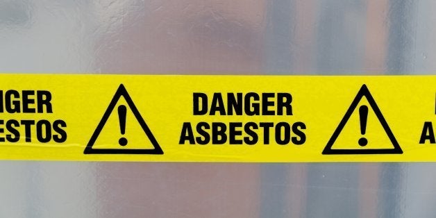 Danger Asbestos yellow warning tape close up