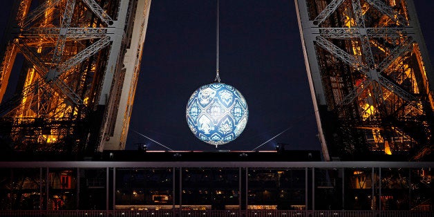 PARIS, FRANCE - NOVEMBER 22: An artwork entitled 'Earth Crisis' by US artist Shepard Fairey is displayed on the Eiffel Tower