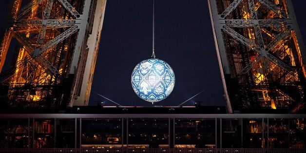 PARIS, FRANCE - NOVEMBER 22: An artwork entitled 'Earth Crisis' by US artist Shepard Fairey is displayed on the Eiffel Tower illuminated, as part of the organisation of the Conference on Climate Change COP21 on November 22 in Paris, France. The climate change conference COP21 will gather 193 countries in Paris from November 30 to December 11, 2015. (Photo by Chesnot/Getty Images)