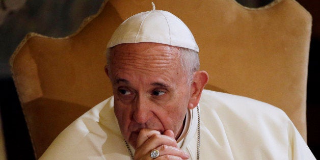 Pope Francis listens to the welcome speech during a visit to the Lutheran church, in Rome, Sunday, Nov. 15, 2015. Pope Francis has condemned the Paris terror attacks, calling it "blasphemy" to use the name of God to justify "the road of violence and of hatred." (AP Photo/Gregorio Borgia)