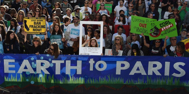 Environmental activists and supporters during a rally calling for action on climate change in Los Angeles, California on November 29, 2015, a day before the start of the COP21 conference in Paris. Some 150 leaders, including US President Barack Obama, China's Xi Jinping, India's Narendra Modi and Russian President Vladimir Putin, will attend the start of the Paris conference, which is tasked with reaching the first truly universal climate pact, with the goal to limit average global warming to two degrees Celsius (3.6 degrees Fahrenheit), perhaps less, over pre-Industrial Revolution levels by curbing fossil fuel emissions blamed for climate change. AFP PHOTO/ MARK RALSTON / AFP / MARK RALSTON (Photo credit should read MARK RALSTON/AFP/Getty Images)