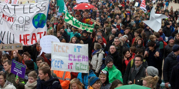 Demonstrators participate in the 'Climate March' protest on December 6, 2015 in Oostende, during the COP21 United Nations Conference on Climate Change in Paris, France. / AFP / BELGA / NICOLAS MAETERLINCK (Photo credit should read NICOLAS MAETERLINCK/AFP/Getty Images)