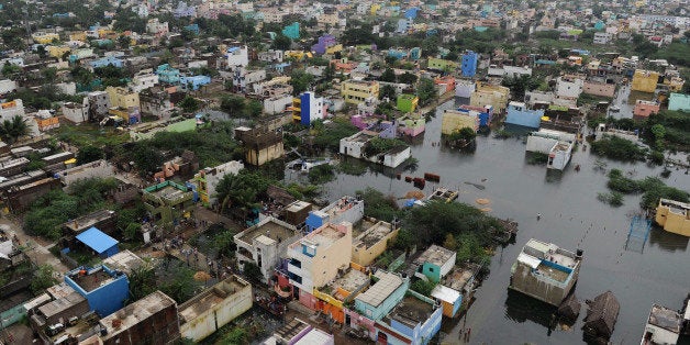 An aerial view from an Indian relief helicopter shows flood affected areas of Chennai on December 5, 2015. Thousands of rescuers are racing to evacuate victims of the Tamil Nadu flooding, which has claimed nearly 300 lives since November 9. Weather officials said rainfall in Chennai had diminished since earlier in the week, but parts of the city of 4.6 million people remained submerged. AFP PHOTO / AFP / STR (Photo credit should read STR/AFP/Getty Images)