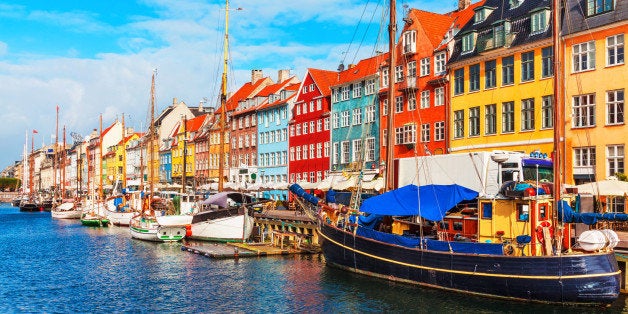 Scenic summer view of Nyhavn pier with color buildings, ships, yachts and other boats in the Old Town of Copenhagen, Denmark