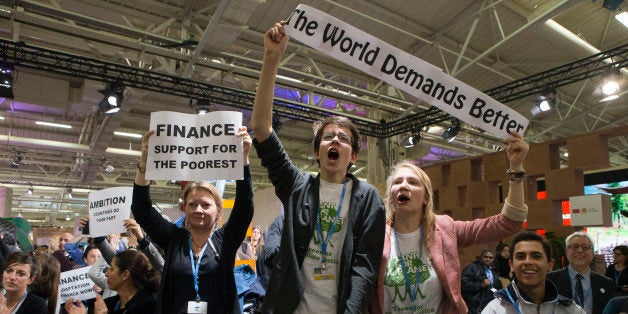 NGO representatives and participants stage a sit-in protest closed to the plenary session to denounce the first draft COP21 Climate Conference agreement, and put pressure to reach an international agreement to limit global warming, during the COP21, United Nations Climate Change Conference in Le Bourget, north of Paris, France, Wednesday, Dec. 9, 2015. (AP Photo/Francois Mori)