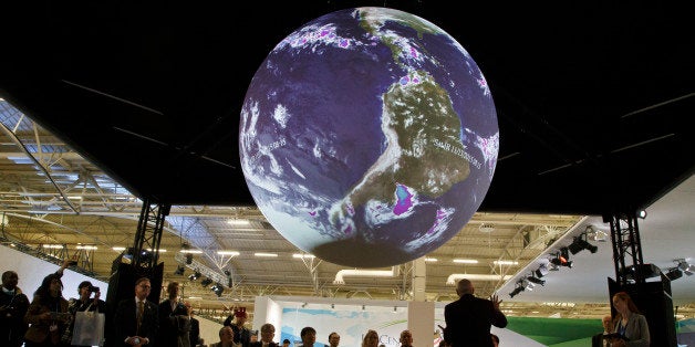 Participants attend a panel entitle"Science on a Sphere Presentation"at the COP21, United Nations Climate Change Conference, in Le Bourget, north of Paris, Tuesday, Dec. 8, 2015. U.S. Secretary of State John Kerry praised business leaders in Paris for taking effective action against climate change but urged them to do more to help decision-makers reach the 2 degree target. (AP Photo/Michel Euler)