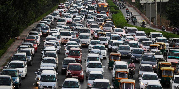 FILE - In this Tuesday, Sept. 23, 2014 file photo, traffic moves at dusk in New Delhi, India. The city is imposing new rules to reduce its notoriously snarled traffic and fight extreme air pollution that has earned Indiaâs capital the title of world's most polluted city. From Jan. 1, for several weeks, private cars will only be allowed on roads on alternate days, depending on whether their license plates end in even or odd numbers. (AP Photo/Altaf Qadri, File)